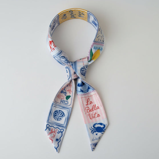 Decorative scarf with colorful patterns and text on a white background