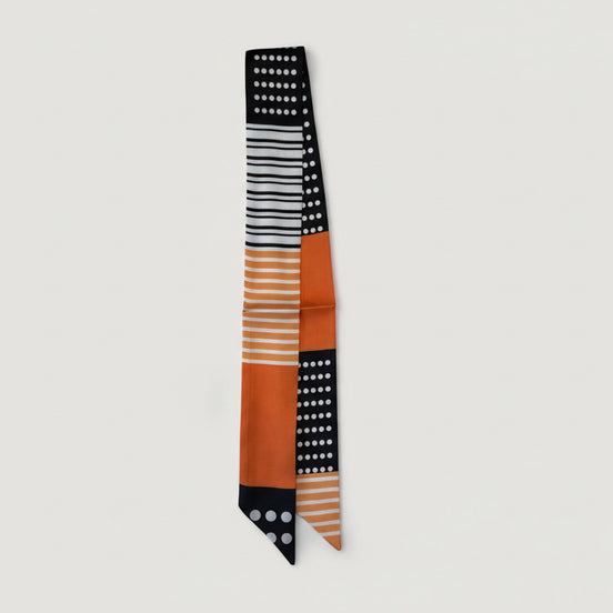 Scarf with black, white, and orange pattern on a white background