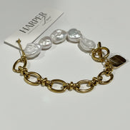Gold bracelet with pearls on a white background