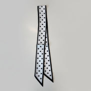 Black and white polka dot pattern on a white surface