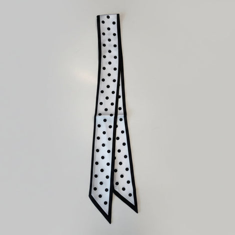 Black and white polka dot pattern on a white surface