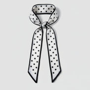 Black and white polka dot scarf on a white background
