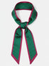 Green and red polka dot ribbon on a white background