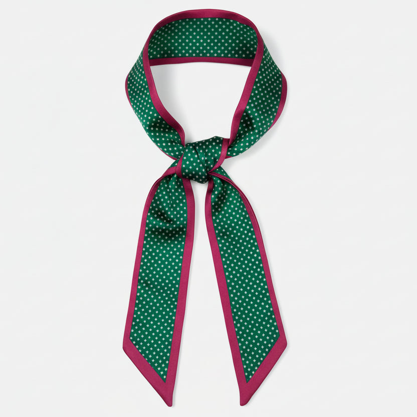 Green and red polka dot ribbon on a white background