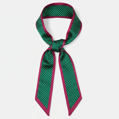 Green and red polka dot ribbon on a white background