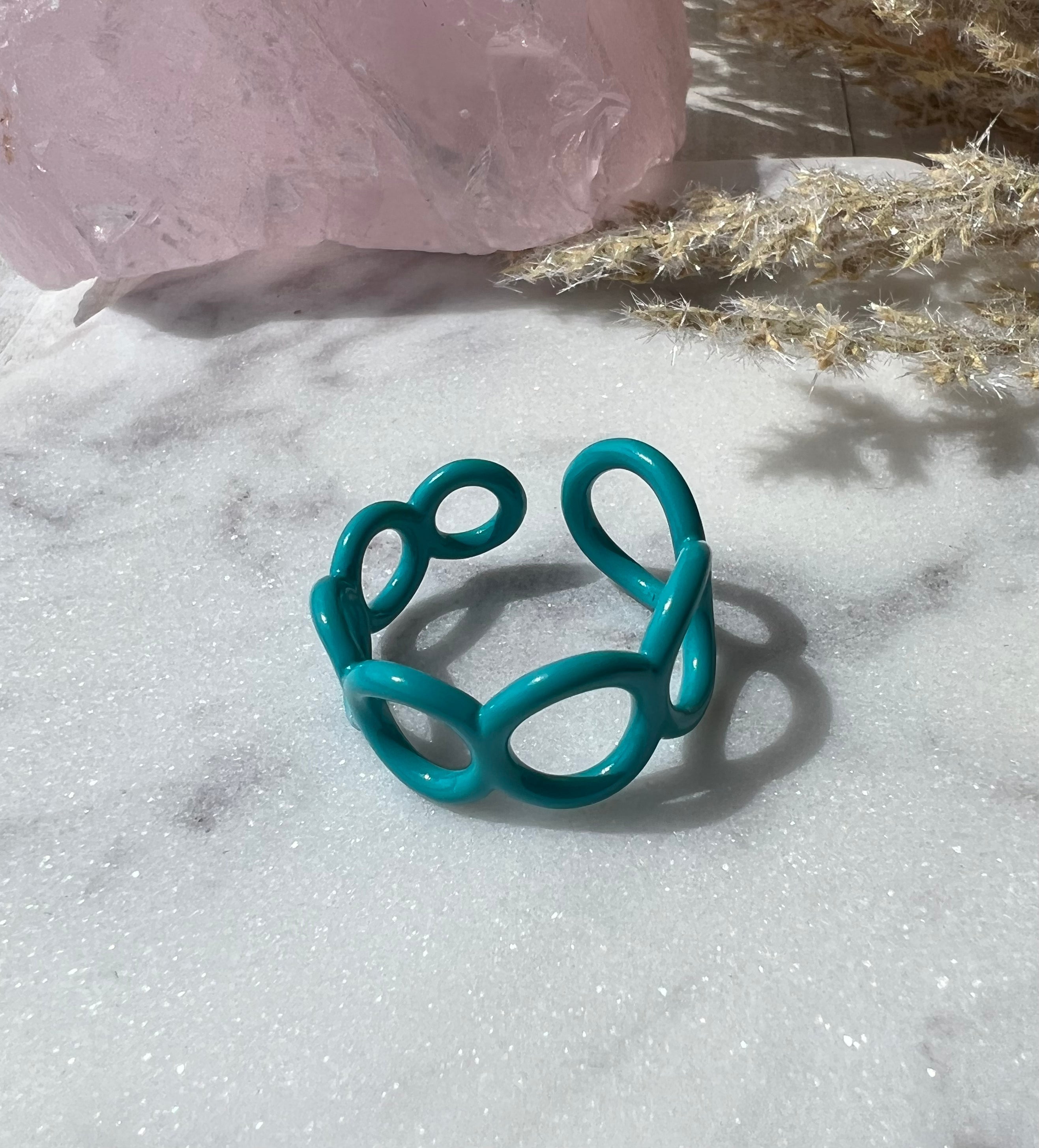 Teal ring with small circle cut outs adjustable in size 
