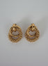 Pair of gold hoop earrings on a light gray background