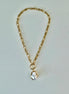 A gold chain pendant necklace with a pearl drop pendant.