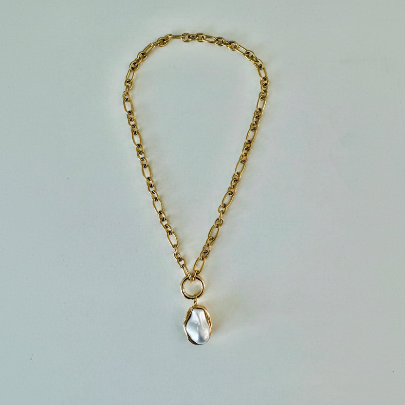 A gold chain pendant necklace with a pearl drop pendant.