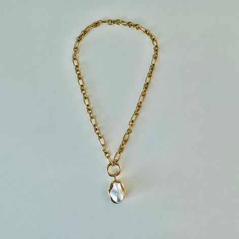 A gold chain pendant necklace with a pearl drop pendant.
