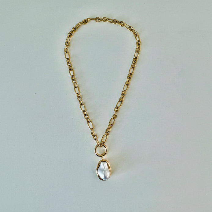 A gold chain pendant necklace with a pearl drop pendant.