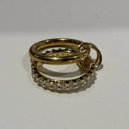 Two gold rings with diamond accents on a white background