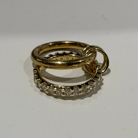 Two gold rings with diamond accents on a white background