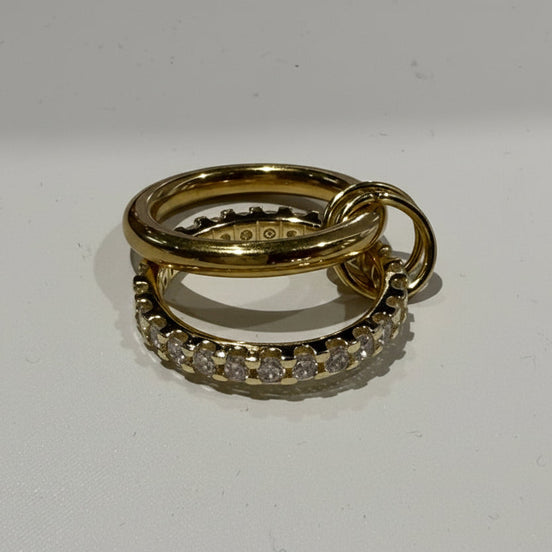 Two gold rings with diamond accents on a white background