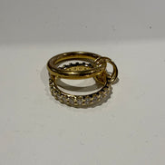 Two gold rings with diamond accents on a white background