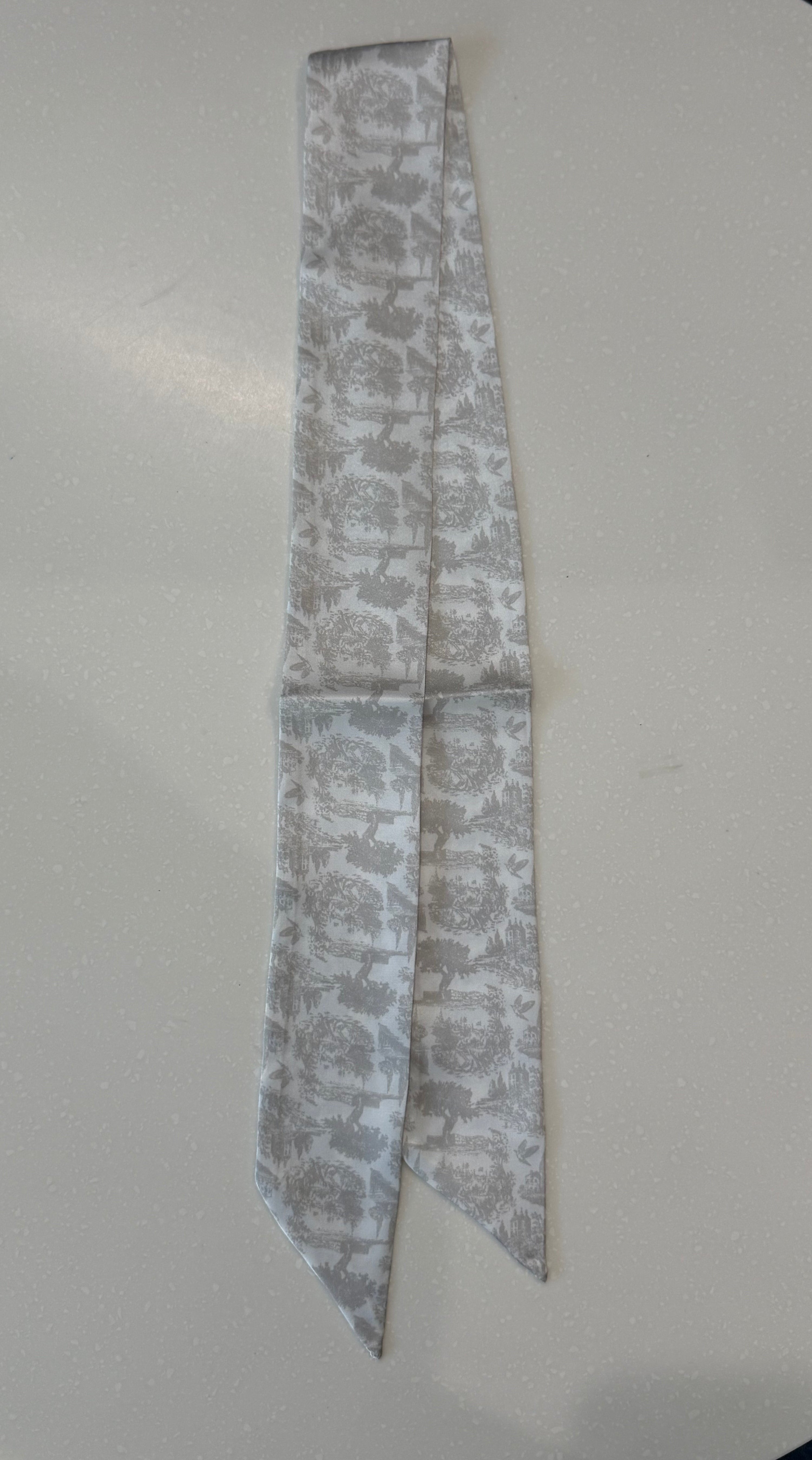 Greige floral toile patterned fabric strips on a white plate