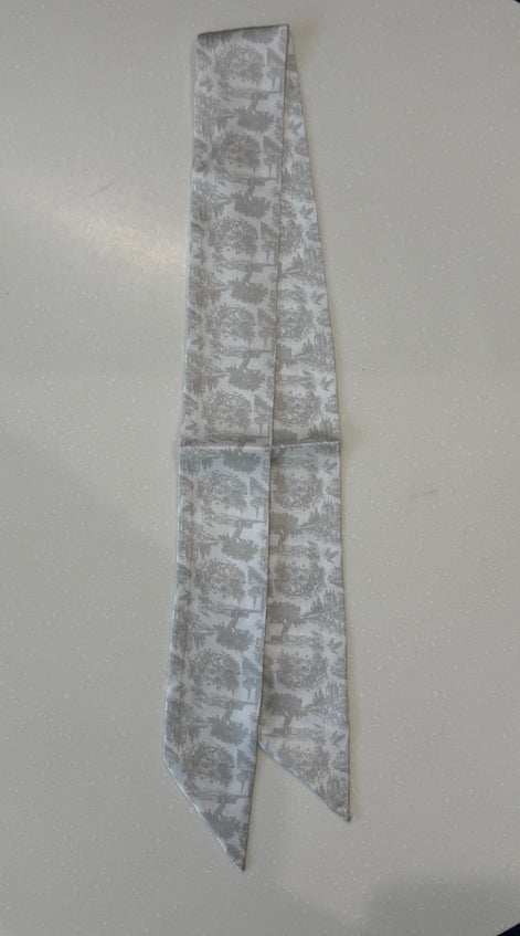 Greige floral toile patterned fabric strips on a white plate
