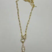 14K gold filled paperclip chain pendant necklace with a micro pave gold lobster clasp that holds a white enamel lightning bolt charm with micro pave accents
