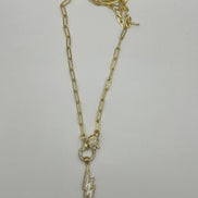 14K gold filled paperclip chain pendant necklace with a micro pave gold lobster clasp that holds a white enamel lightning bolt charm with micro pave accents