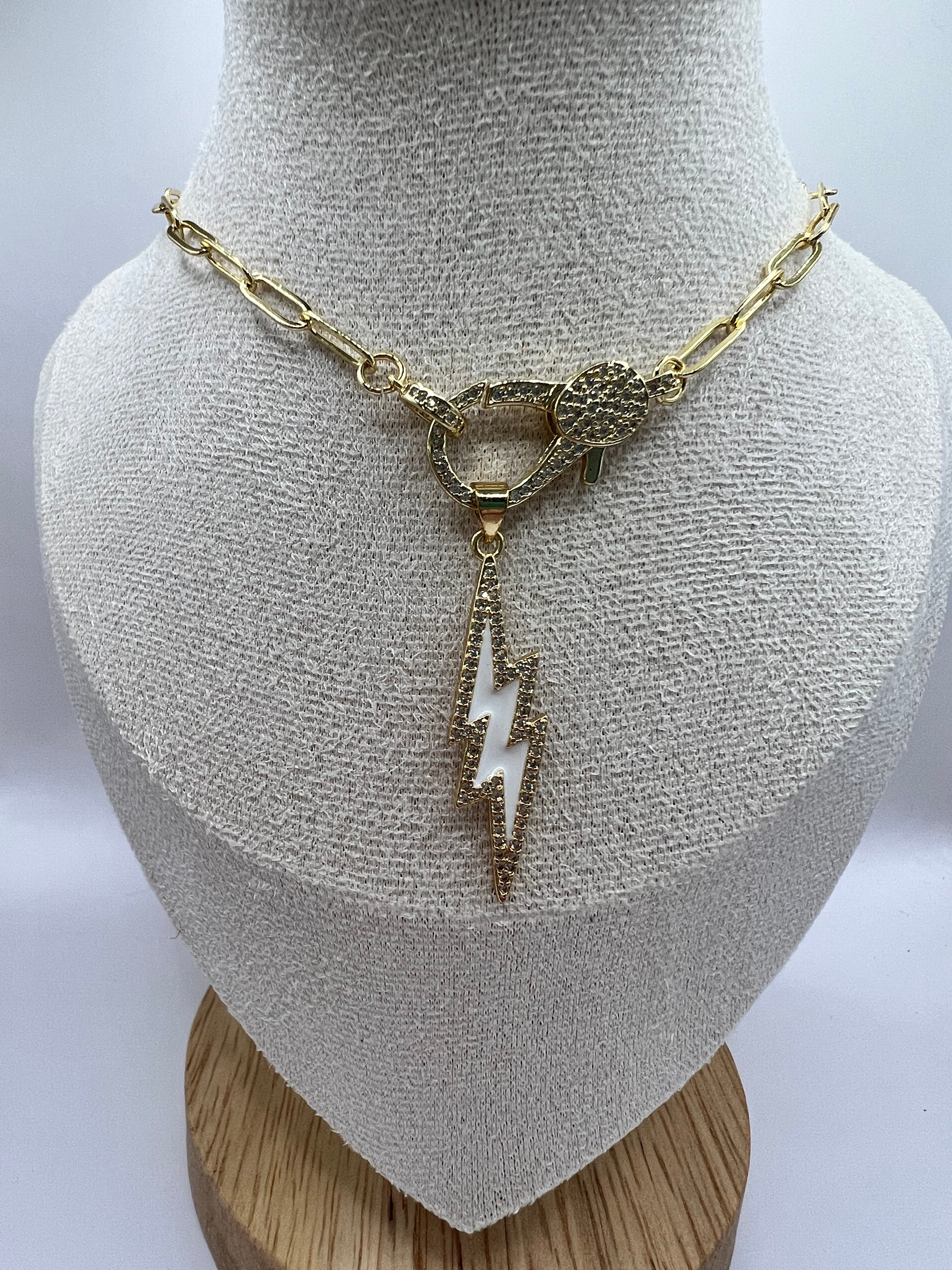 14K gold filled paperclip chain pendant necklace with a micro pave gold lobster clasp that holds a white enamel lightning bolt charm with micro pave accents