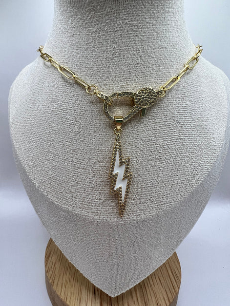 14K gold filled paperclip chain pendant necklace with a micro pave gold lobster clasp that holds a white enamel lightning bolt charm with micro pave accents