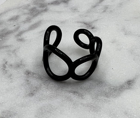 Black colored enamel ring with small circle cut outs adjustable in size