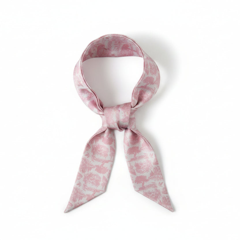 Long, narrow scarf with pink floral toile pattern on a white background
