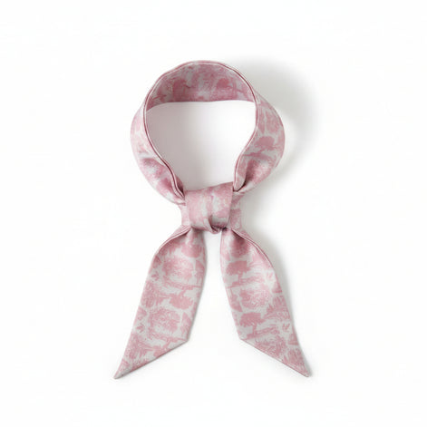 Long, narrow scarf with pink floral toile pattern on a white background