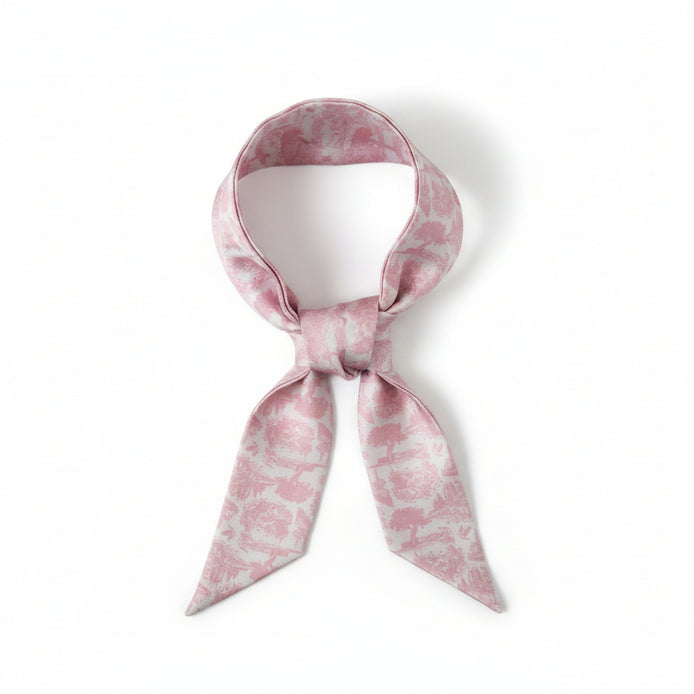 Long, narrow scarf with pink floral toile pattern on a white background