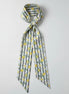Scarf with lemon pattern and thin black stripes on a white background