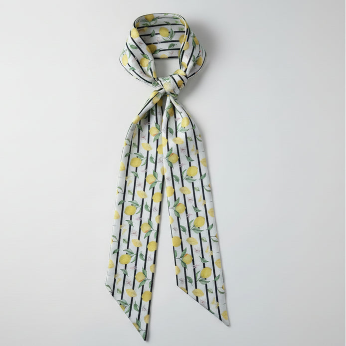 Scarf with lemon pattern and thin black stripes on a white background