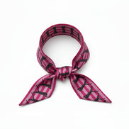 Pink and black patterned scarf with leopards on a white background