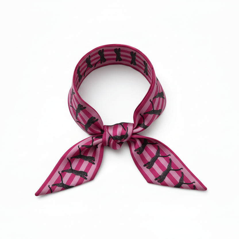 Pink and black patterned scarf with leopards on a white background