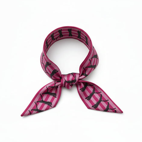 Pink and black patterned scarf with leopards on a white background