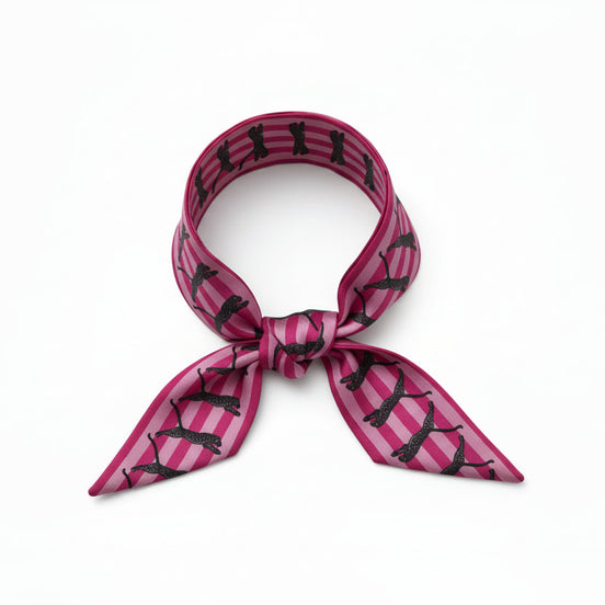 Pink and black patterned scarf with leopards on a white background