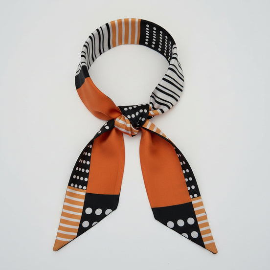 Scarf with black, white, and orange pattern on a white background