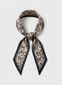 Beige leopard print scarf with black border on a white background