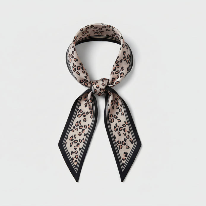 Beige leopard print scarf with black border on a white background