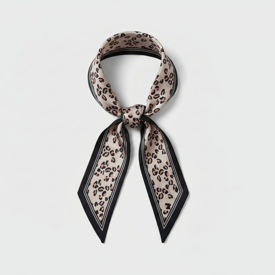 Beige leopard print scarf with black border on a white background