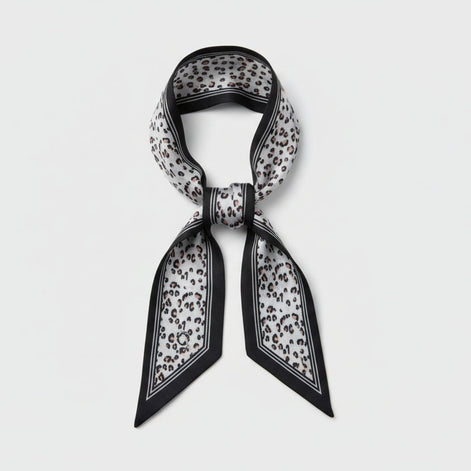 Scarf with black vertical lines with a beige and black leopard print design on a white background