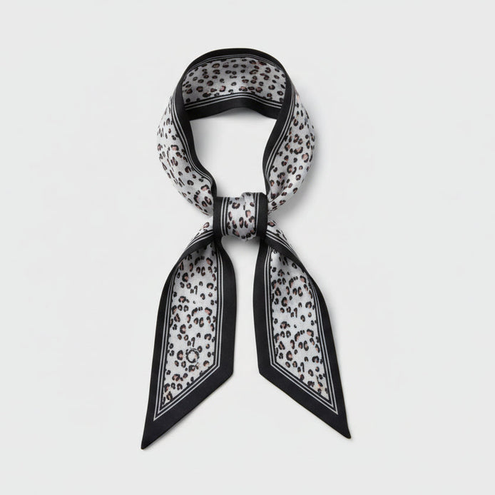 Scarf with black vertical lines with a beige and black leopard print design on a white background