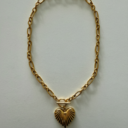 An 18k gold stainless steel scalloped heart necklace with a gold chain and a gold heart-shaped pendant.