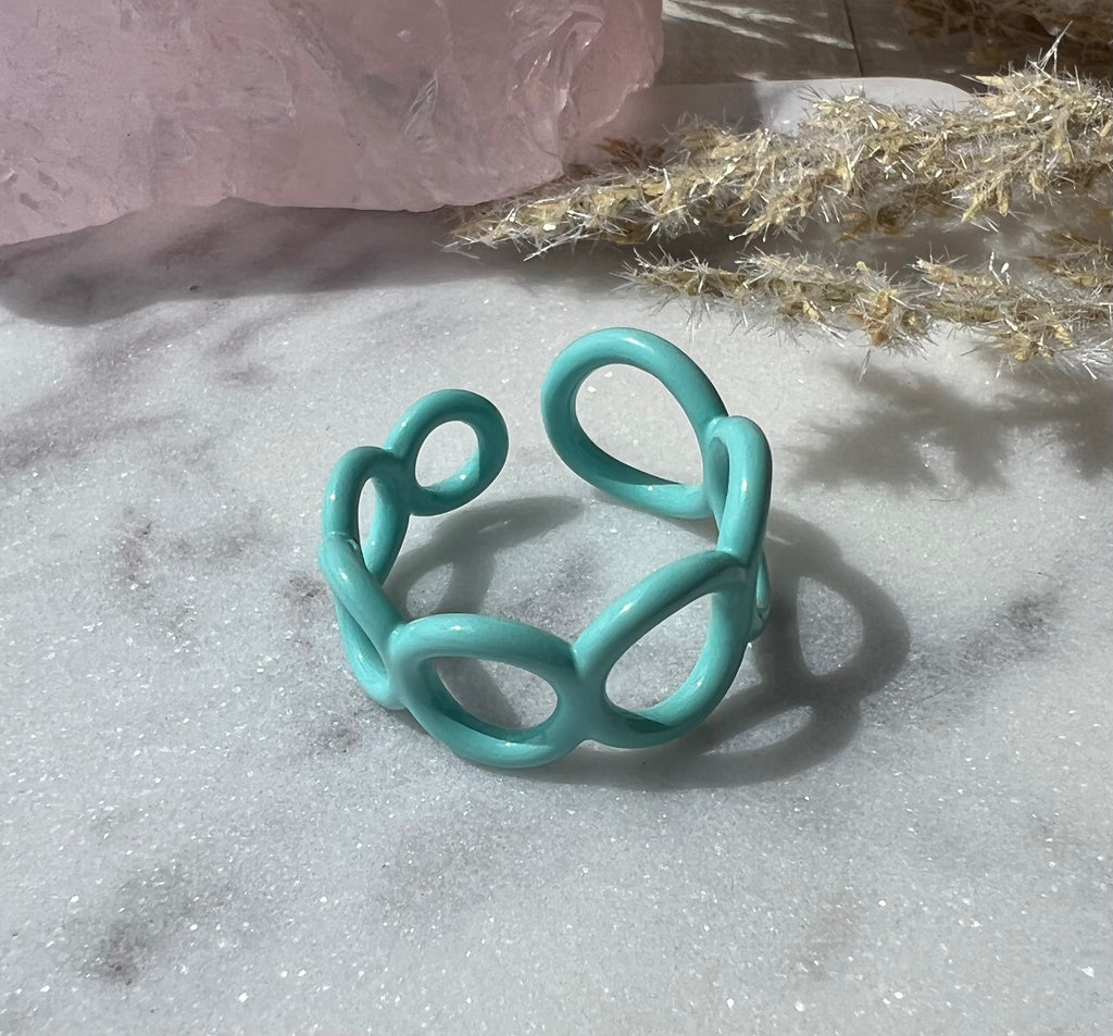Mint green blue colored enamel ring with small circle cut outs adjustable in size