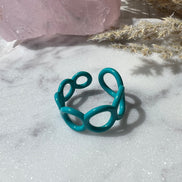 Teal ring with small circle cut outs adjustable in size 