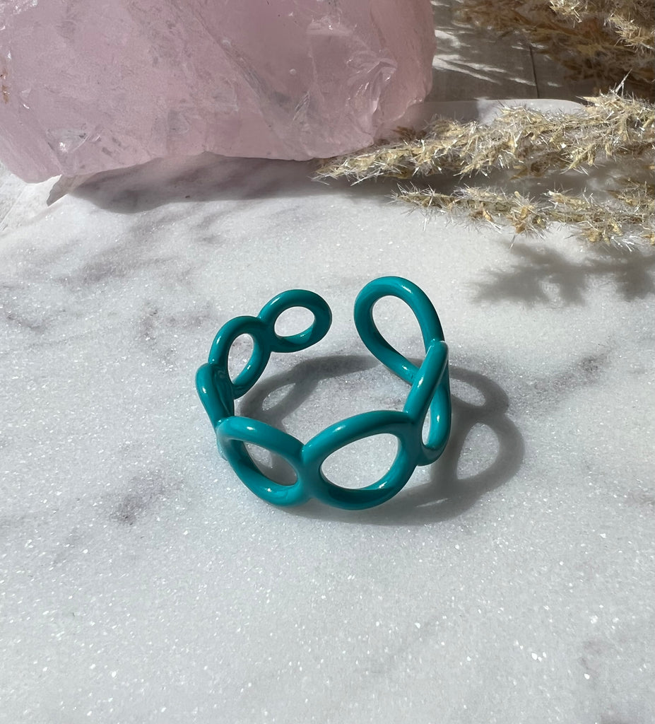 Teal ring with small circle cut outs adjustable in size 