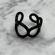 Black colored enamel ring with small circle cut outs adjustable in size