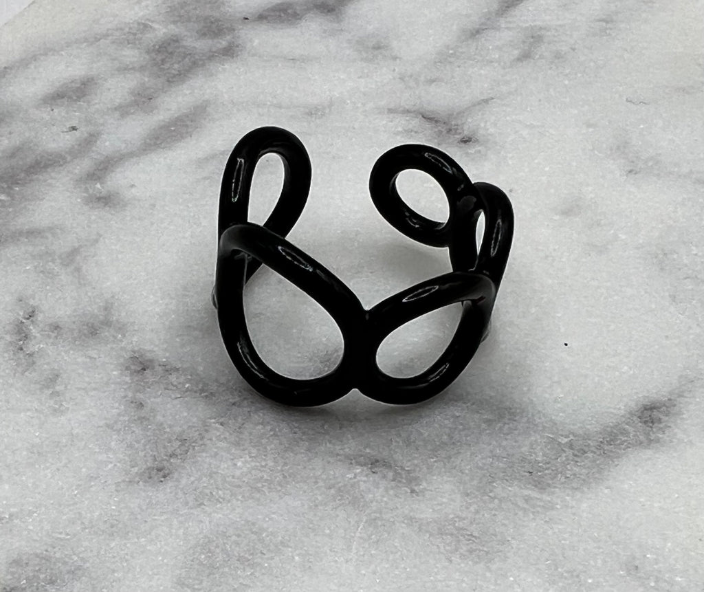 Black colored enamel ring with small circle cut outs adjustable in size